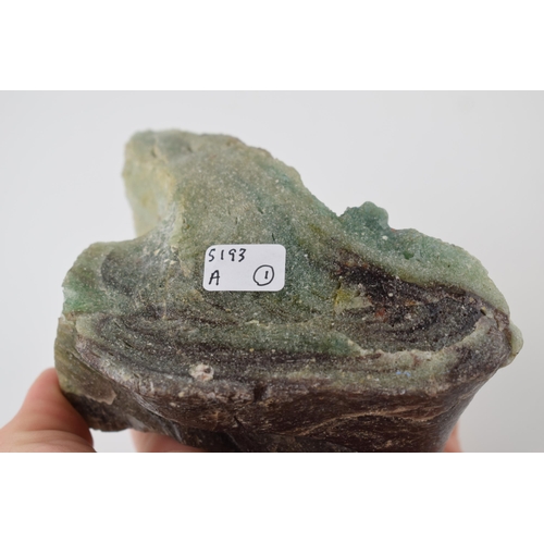 622 - A specimen of volcanic glass / fluorite in green and purple. Dimensions 13cm x 7cm x 8cm. Weight 556... 