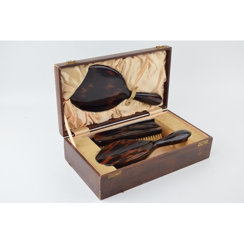 636 - Vintage tortoiseshell vanity set to include, brush, mirror, comb and flat brush in leather case with... 