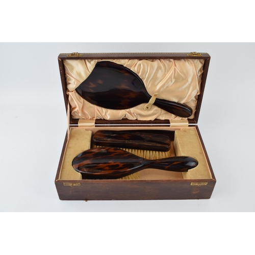 636 - Vintage tortoiseshell vanity set to include, brush, mirror, comb and flat brush in leather case with... 