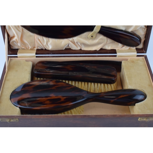 636 - Vintage tortoiseshell vanity set to include, brush, mirror, comb and flat brush in leather case with... 