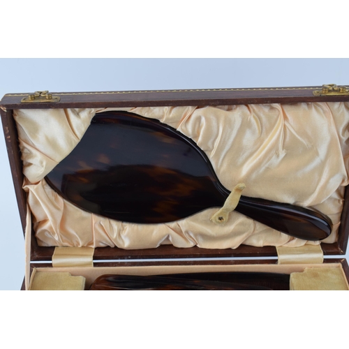 636 - Vintage tortoiseshell vanity set to include, brush, mirror, comb and flat brush in leather case with... 