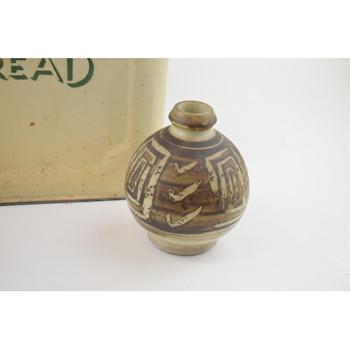 648 - An original vintage enamel bread bin with green writing together with a studio pottery stoneware vas... 