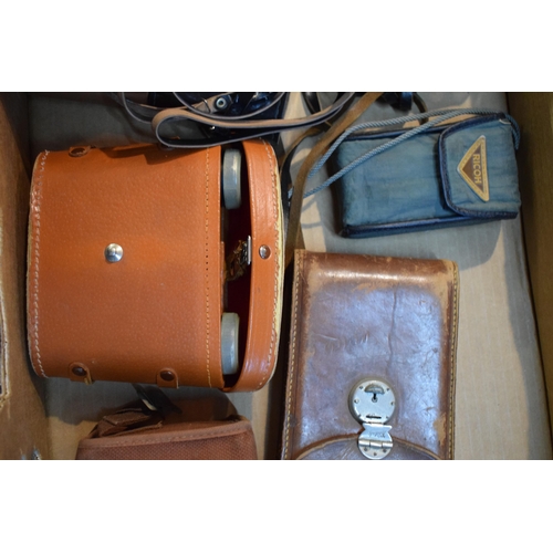 650 - A collection of vintage cameras and binoculars to include a Zorki - 4 35mm camera with lens, an OMO ... 