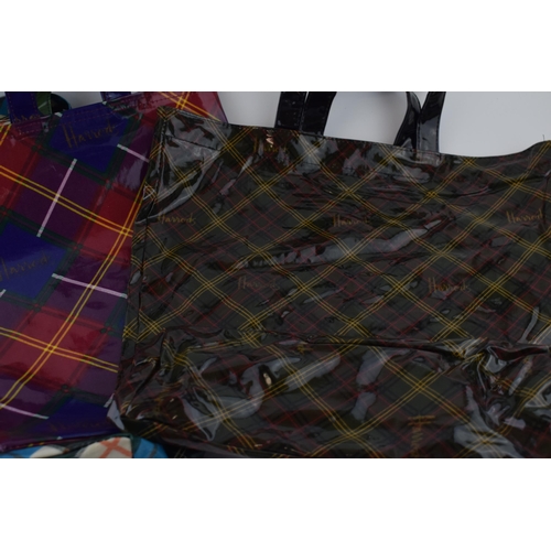 660 - A collection of 'Harrods' new old stock vintage shopper bags in tartan colour-ways. With original ta... 