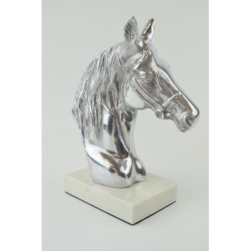 667 - A contemporary aluminium bust in the form of a horse's head on a white marble base, 23.5cm tall.