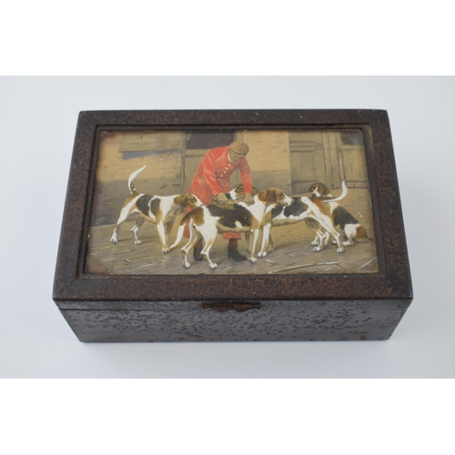 669 - An antique cigarette tin with hand-painted scene under glass of huntsman grooming his hounds. Dimens... 