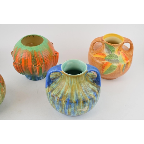 77 - A collection of Wade Art Deco vases to include a matched pair of two-handled Wade Heath vases with 2... 