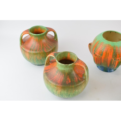 77 - A collection of Wade Art Deco vases to include a matched pair of two-handled Wade Heath vases with 2... 