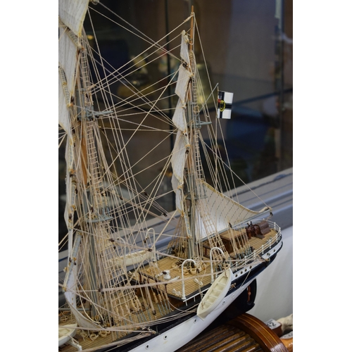 581 - Kit built model of a sailing vessel / galleon, with German flag, mounted onto wooden stand, mostly i... 