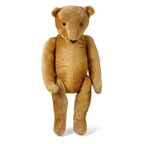 144 - A large early 20th century straw filled teddy bear, circa 1920/30s, with jointed limbs and glass eye... 