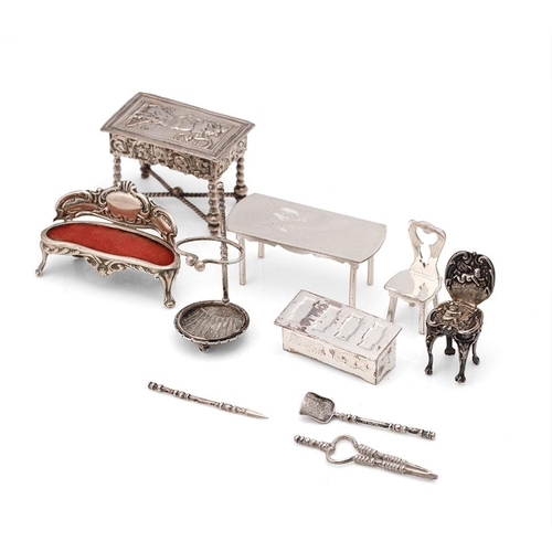 221 - A collection of miniature silver furniture to include a grand sofa, Birm 1902, a .930 silver heavily... 