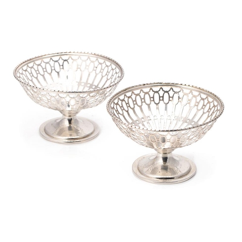 243 - A pair of silver bon bon dishes with ornate pierced decoration, Birm 1921, E S Barnsley, 76.8 grams ... 