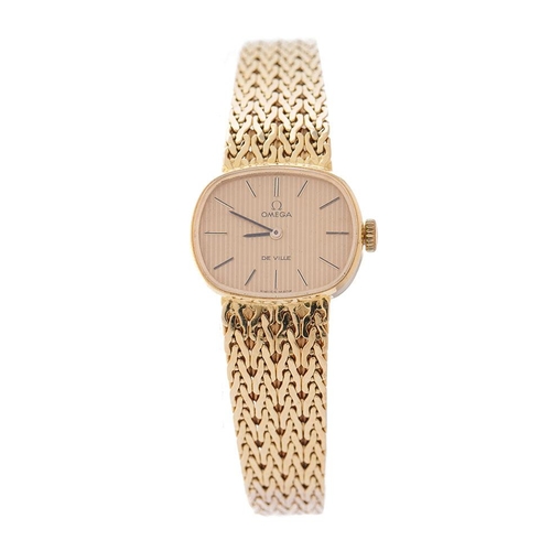 307 - A ladies Omega De Ville 18ct gold wristwatch. Goldtone dial with applied baton markers. 18ct gold br...