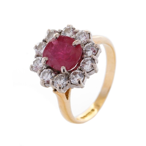 368 - An 18ct yellow gold ruby and diamond cluster ring, with central oval-cut ruby and border of ten roun... 