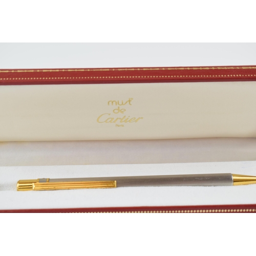 136 - Must de Cartier Ballpoint-Pen, with brushed finish and gilt-metal highlights, serial number C19272, ... 