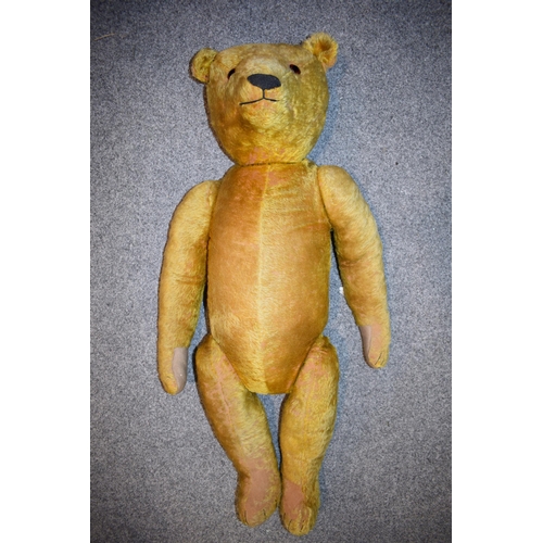 144 - A large early 20th century straw filled teddy bear, circa 1920/30s, with jointed limbs and glass eye... 