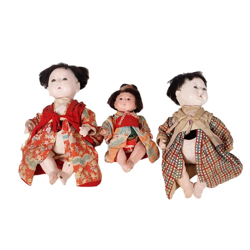 148 - Trio of antique Japanese dolls. Composite heads with cork limbs to include father, mother and child.... 