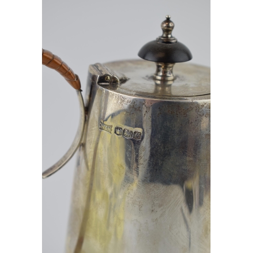 192 - Hallmarked sterling silver coffee pot with ebonised finial and wicker handle, Walker and Hall, Sheff... 