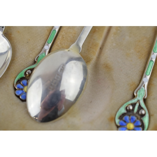 208 - A stunning cased set of hallmarked silver tea spoons with enamelled decoration in the form of flower... 