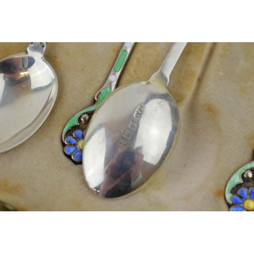 208 - A stunning cased set of hallmarked silver tea spoons with enamelled decoration in the form of flower... 