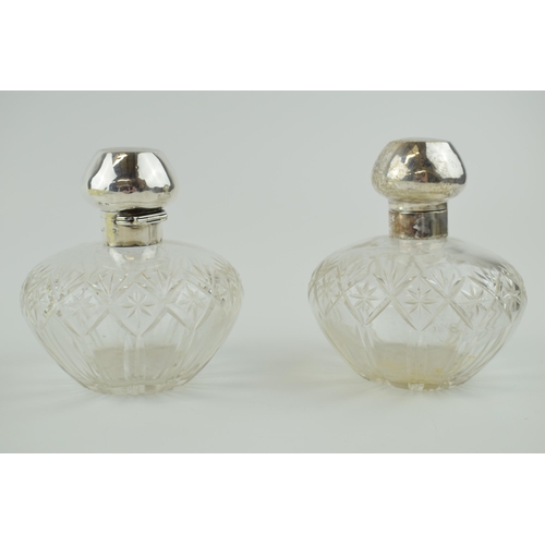 248 - A pair of matching silver topped cut glass perfume bottles, Birm 1923, Levi & Salaman (2), 10cm tall... 