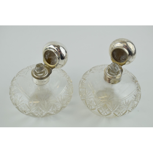 248 - A pair of matching silver topped cut glass perfume bottles, Birm 1923, Levi & Salaman (2), 10cm tall... 