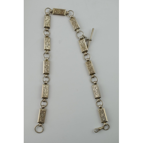 295 - White metal (tests as silver) albert chain with ornate rectangular links with engraved floral decora... 