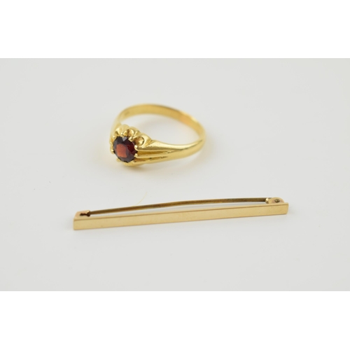 385 - 18ct gold ring set with central garnet, size X, 7.1 grams,  together with a 9ct gold tie pin with me... 