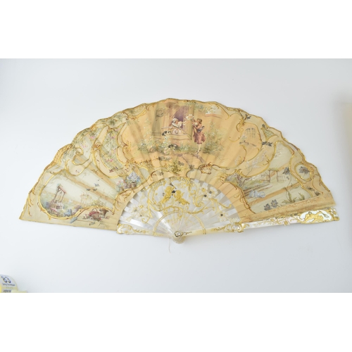 78 - Edwardian silk decorated fan with highly worked and gilded mother of pearl front & rear, and in orig... 