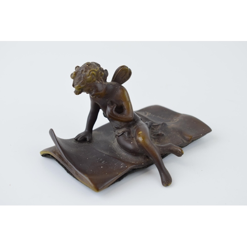 84 - Ernest Justin Ferrand (French 1846-1932) a small patinated bronze figure of cupid seated on a letter... 