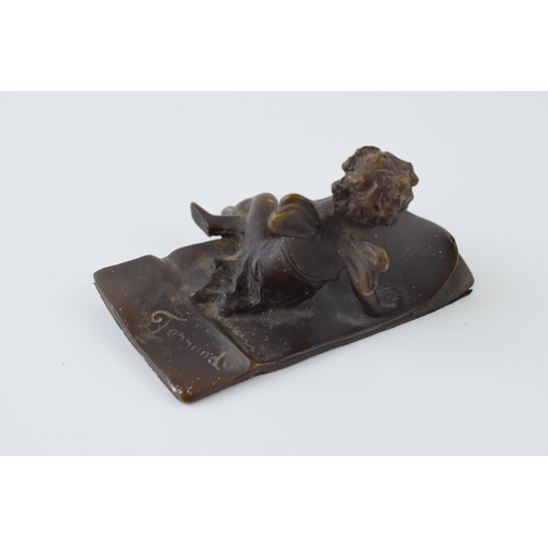 84 - Ernest Justin Ferrand (French 1846-1932) a small patinated bronze figure of cupid seated on a letter... 