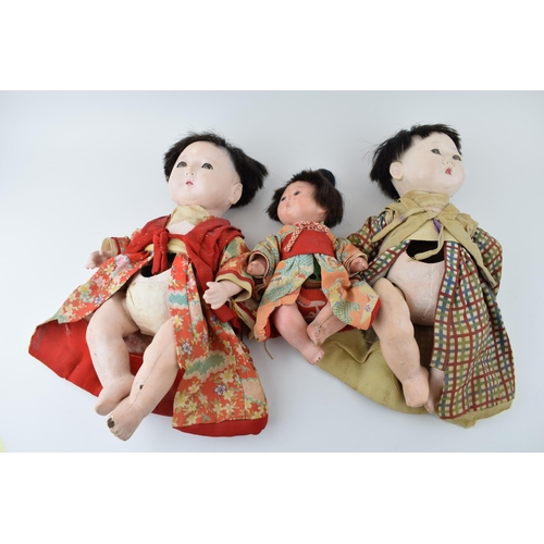 148 - Trio of antique Japanese dolls. Composite heads with cork limbs to include father, mother and child.... 