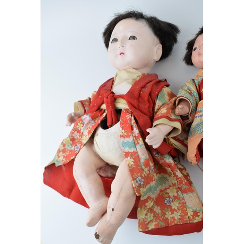 148 - Trio of antique Japanese dolls. Composite heads with cork limbs to include father, mother and child.... 