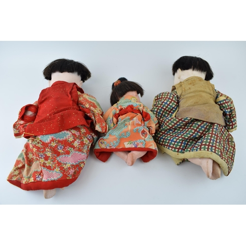 148 - Trio of antique Japanese dolls. Composite heads with cork limbs to include father, mother and child.... 