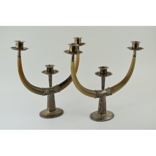 216 - A pair of mid 20th century Eastern silver and horn two branch, three light candelabra, with engraved... 