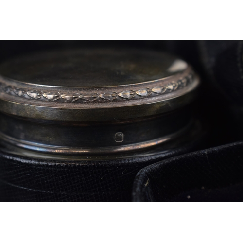 228 - A leather cased travelling case to include 6 silver topped jars of varying sizes and forms with indi... 