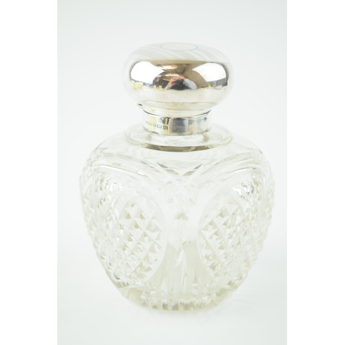 245 - Silver topped cut glass perfume bottle, with glass stopper, Birm 1919, H and H Ltd, 11cm tall.