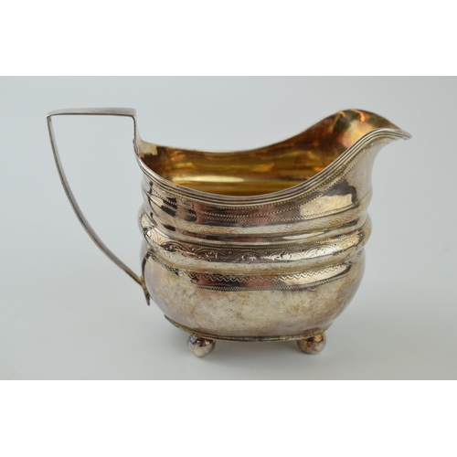 254 - George III silver cream jug, engraved decoration, sat on four ball feet, London 1809, 102.0 grams.