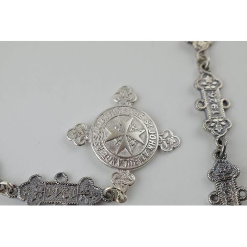 272 - An unusual silver 'St Johns Ambulance' silver fob with silver year link chain, 75.6 grams, 61cm long... 