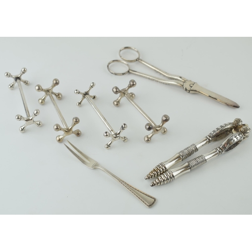 286 - A collection of silver plated items to include knife rests, a nutcracker set and others.