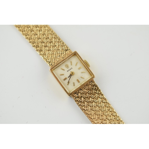 306 - A ladies 9ct Rolex wristwatch. Square white dial with applied baton markers and Rolex crown at 12 o'... 