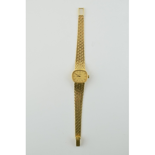 307 - A ladies Omega De Ville 18ct gold wristwatch. Goldtone dial with applied baton markers. 18ct gold br... 