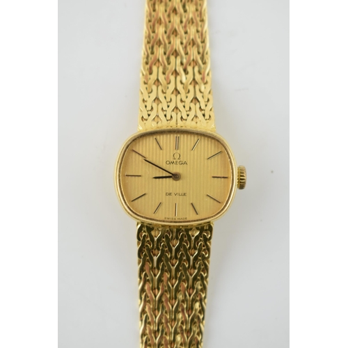 307 - A ladies Omega De Ville 18ct gold wristwatch. Goldtone dial with applied baton markers. 18ct gold br... 