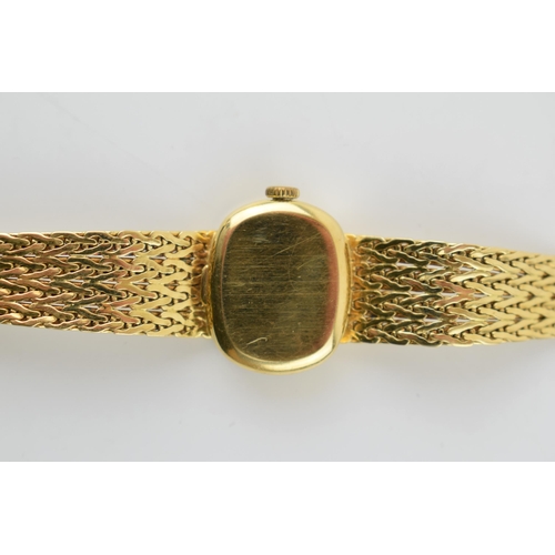 307 - A ladies Omega De Ville 18ct gold wristwatch. Goldtone dial with applied baton markers. 18ct gold br... 