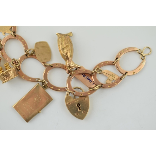 350 - 9ct rose gold horseshoe themed charm bracelet  and containing 12 x 9ct charms, including padlock.  W... 