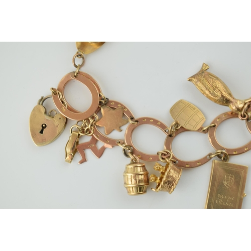 350 - 9ct rose gold horseshoe themed charm bracelet  and containing 12 x 9ct charms, including padlock.  W... 