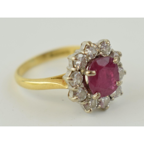 368 - An 18ct yellow gold ruby and diamond cluster ring, with central oval-cut ruby and border of ten roun... 