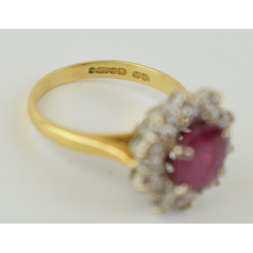 368 - An 18ct yellow gold ruby and diamond cluster ring, with central oval-cut ruby and border of ten roun... 