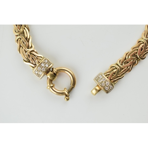 375 - 9ct yellow gold fancy link bracelet, highlighted with white stone collars, 10.9 grams, 19.5cm long.