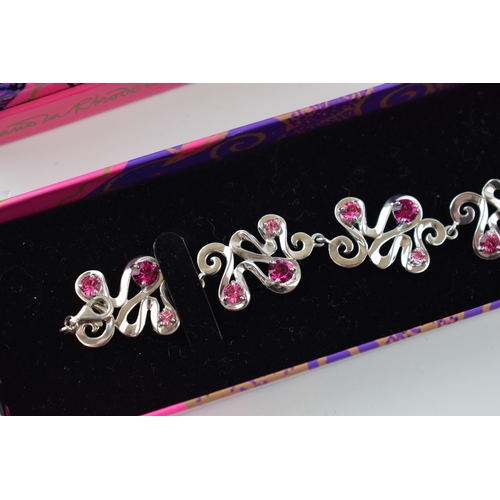 382 - Boxed Zandra Rhodes silver bracelet of scrolled links, set pink paste, 24.8 grams, 20cm long.